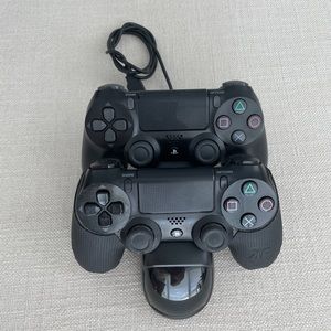 Two (2) PlayStation 4 wireless controllers with charging base